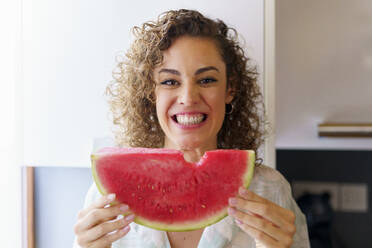 Happy beautiful woman holding slice of watermelon - JSMF02893
