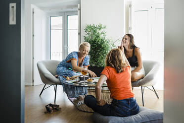 Happy friends enjoying and having snacks together in apartment - DCRF01688