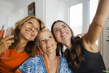 Happy young woman taking selfie with friends - DCRF01693