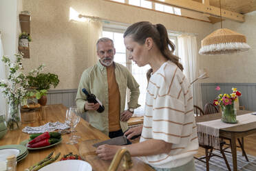 Man and woman preparing food in kitchen at home - VPIF08362