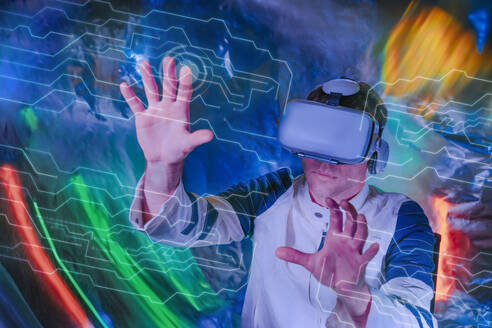 Mann berührt transparenten Bildschirm und gestikuliert mit Virtual-Reality-Simulatoren - YTF01073