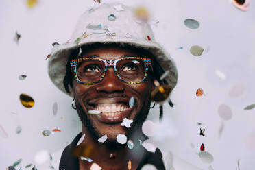 Portrait of an hip hop music musician. Cinematic image of a man under confetti drop - DMDF01748