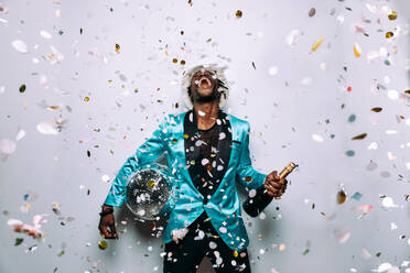 Portrait of an hip hop music musician. Cinematic image of a man under confetti drop - DMDF01752