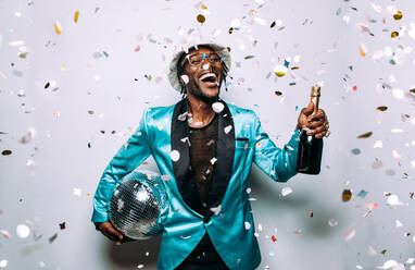 Portrait of an hip hop music musician. Cinematic image of a man under confetti drop - DMDF01753