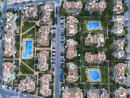 Spain, Valencian Community, Mil Palmeras, Aerial view of villas surrounding three swimming pools - DMHF00098