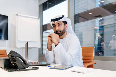 Middle-eastern businessman wearing traditional arab kandura working in the office in Dubai - Adult arabian business man working in the UAE - DMDF02248