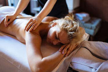 Beautiful woman relaxing in a beauty spa hotel - Client having a beauty treatment in a beauty spa salon - DMDF02275