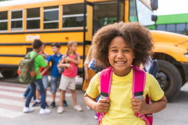 Group of young students attending primary school on a yellow school bus - Elementary school kids ha1ving fun - DMDF02413