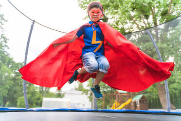 Kid wearing superhero costumes and having fun outdoors - DMDF02419