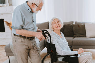 Disabled old woman on wheel chair - Senior couple at home, partner coming back from hospital in convalescence - DMDF02456