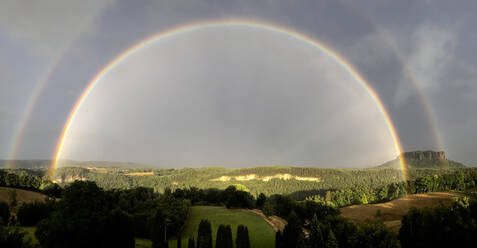 Germany, Saxony, Panoramic view of double rainbow in Saxon Switzerland - JTF02364