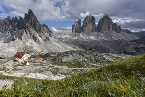 Italien, Abgeschiedene Hütte in den Dolomiten mit den Drei Zinnen von Lavaredo im Hintergrund - FDF00393