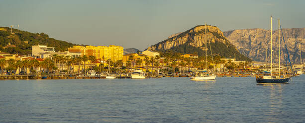 View of boats and colourful buildings at sunset in Golfo Aranci, Sardinia, Italy, Mediterranean, Europe - RHPLF26794