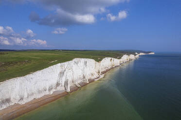 Aerial view of the Seven Sisters chalk white cliffs on a sunny day, South Downs National Park, East Sussex, England, United Kingdom, Europe - RHPLF26886