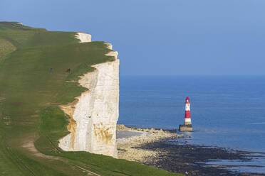 View of the coast of the Seven Sisters white chalk cliffs with the Beachy Head lighthouse in the background, South Downs National Park, East Sussex, England, United Kingdom, Europe - RHPLF26887