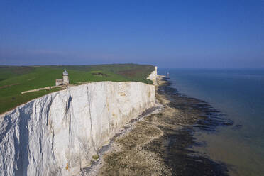 View from drone of Belle Tout lighthouse at low tide, Seven Sisters chalk cliffs, South Downs National Park, East Sussex, England, United Kingdom, Europe - RHPLF26889