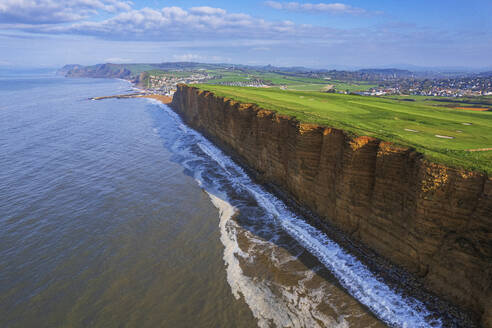 Aerial morning view of the West Bay cliffs on coastline of the Jurassic Coast, UNESCO World Heritage Site, Dorset, England, United Kingdom, Europe - RHPLF26897