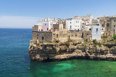 Polignano a mare, the medieval and white sea town facing the turquoise water of the Adriatic Sea, day time, Bari, Apulia, Mediterranean Sea, Italy, Europe - RHPLF26936