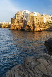 View of the medieval village of Polignano a Mare on top of the cliff at sunset, Bari, Apulia, Adriatic Sea, Mediterranean Sea, Italy, Europe - RHPLF26938