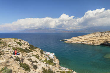 Tourist enjoying the view of the bay of Matala, Iraklion, Crete, Greek Islands, Greece, Europe - RHPLF26966