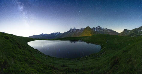 Andossi lake lit by glowing stars in the night sky, Madesimo, Valle Spluga, Valtellina, Lombardy, Italy, Europe - RHPLF27033