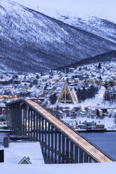 Dusk over the illuminated Bruvegen Bridge and Arctic Cathedral in winter, Tromso, Norway, Scandinavia, Europe - RHPLF27035