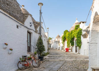 Whitewashed trulli houses along street in the old town, UNESCO World Heritage Site, Alberobello, Puglia, Italy, Europe - RHPLF27047