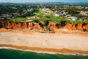 Aerial drone view of Praia de Vale do Lobo with magnificent golf courses overlooking the ocean in Algarve, Portugal, Europe - RHPLF27087