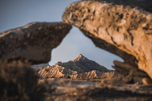 Badlands of Bardenas Reales mountains framed by two rocks, Navarre, Spain, Europe - RHPLF27177