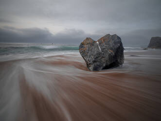 Long exposure of the flowing sea and a heart shaped rock on the Portizuelo beach, Asturias, Spain, Europe - RHPLF27184