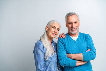 Beautiful senior couple of lovers - Elderly people portrait on white background - DMDF02835