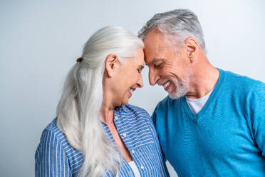 Beautiful senior couple of lovers - Elderly people portrait on white background - DMDF02836