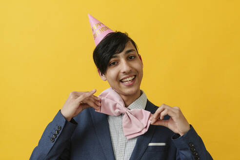 Smiling young man wearing bow tie on birthday - OSF02034