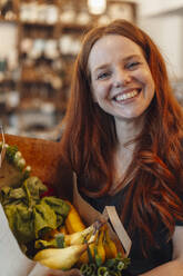 Happy redhead woman shopping for groceries - KNSF09691