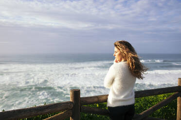 Young woman enjoying sunlight by sea - DCRF01746