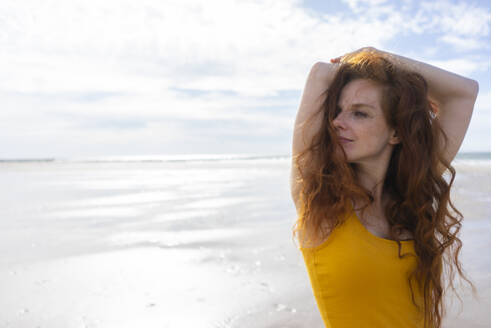 Redhead woman relaxing on summer vacation at beach - KNSF09714