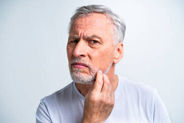 Handsome senior man portrait, studio shot on background - Elderly person, half body shot - DMDF03036