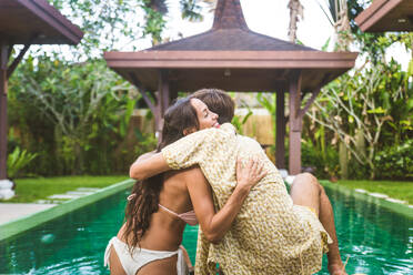 Couple of lovers in a beautiful villa with swimming pool in a tropical climate location - Happy people on a summer vacation, influencers enjoying a luxury resort - DMDF03067