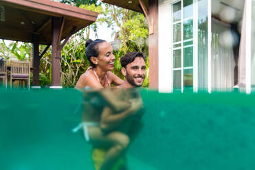 Couple of lovers in a beautiful villa with swimming pool in a tropical climate location - Happy people on a summer vacation, influencers enjoying a luxury resort - DMDF03112