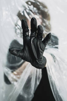 Woman's hand with black plastic glove - SVCF00388