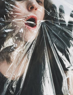 Woman suffocating behind plastic - SVCF00389