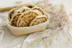 Homemade sourdough pita breads in basket - ONAF00618