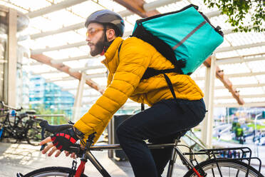 Lebensmittellieferdienst, Fahrer, der mit dem Fahrrad Essen in Kliniken ausliefert - Konzepte zu Transport, Lebensmittellieferung und Technologie - DMDF03183