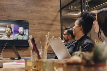 Business colleagues in meeting through video conference at board room - MASF37827