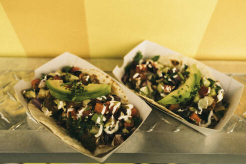 Pair of fresh tacos in take away boxes on concession stand - MASF38041
