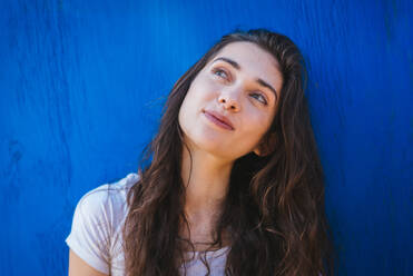 Outdoor portrait of young beautiful happy smiling girl posing on