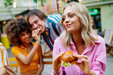 Multiracial young people together meeting and having party in a restaurant - Group of friends with mixed races having fun celebrating in a bar- Friendship and lifestyle concepts - DMDF03430