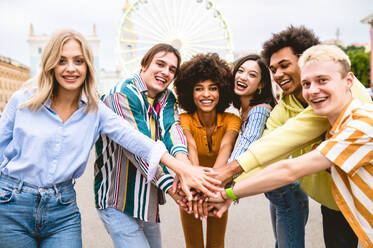 Multiracial young people together meeting and social gathering - Group of friends with mixed races having fun outdoors in the city- Friendship and lifestyle concepts - DMDF03469