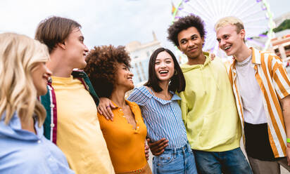 Multiracial young people together meeting and social gathering - Group of friends with mixed races having fun outdoors in the city- Friendship and lifestyle concepts - DMDF03477