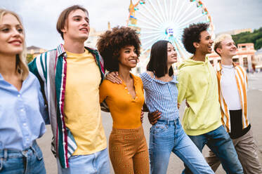 Multiracial young people together meeting and social gathering - Group of friends with mixed races having fun outdoors in the city- Friendship and lifestyle concepts - DMDF03480